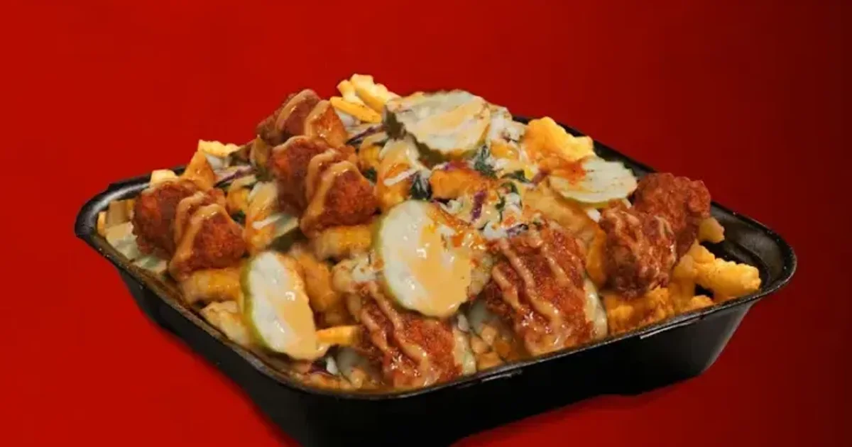 Dave's Hot Chicken Top-Loaded Fries with cheese sauce, pickles, slaw and bites — best sides guide